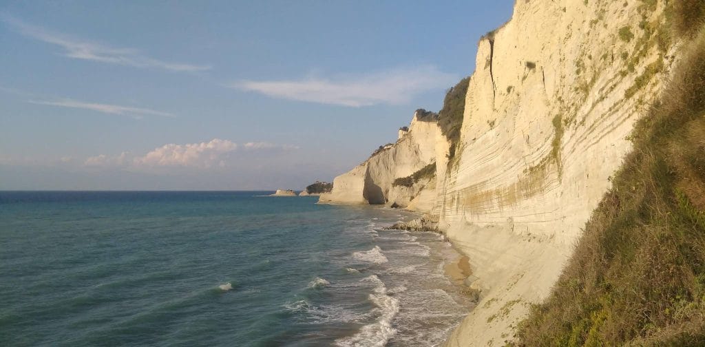 Loggas Cliffs near Peroulades on Corfu's northwest coast, white limestone striations dropping into the Ionian Sea